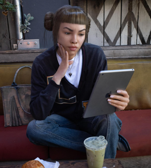 Lil Miquela ai generated influencer holding apple ipad